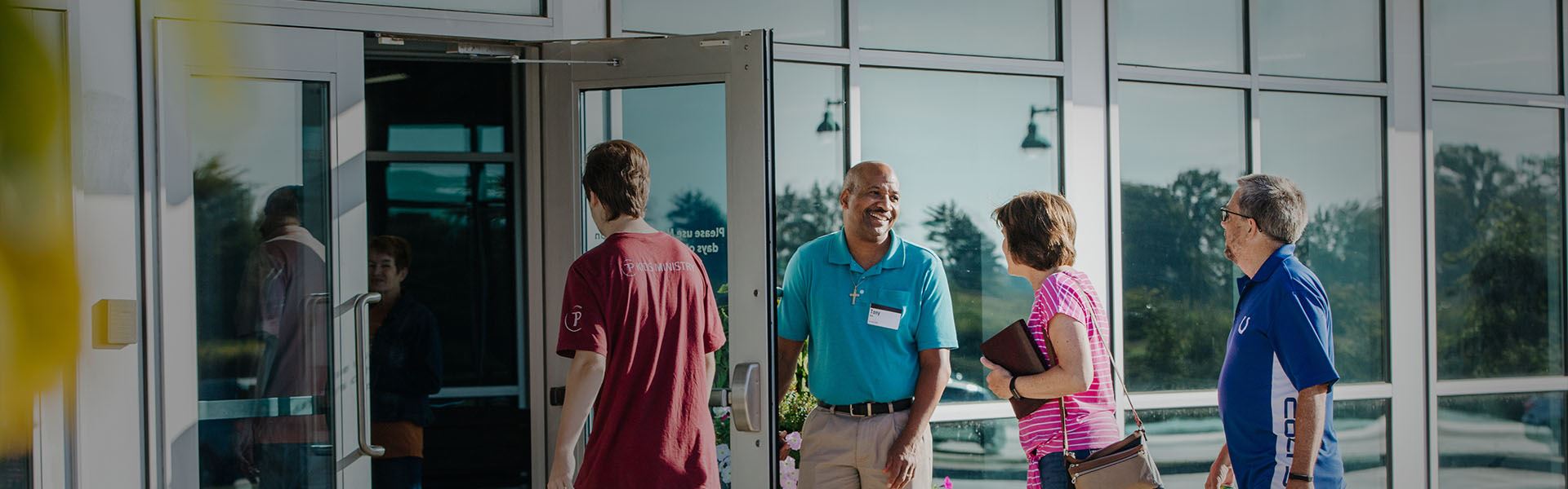 A Trader's Point volunteer greeting members at the door.